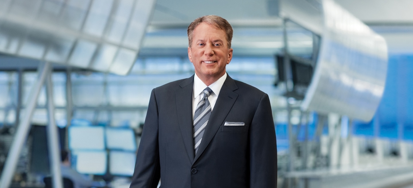 Photo of CME Group Chairman and Chief Executive Officer Terrence A. Duffy, sitting at a desk, with his hands folded.